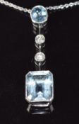 An 18ct white gold necklace set with an oval cut aquamarine of approximately 0.5ct, two diamonds