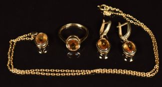 A suite of 14k gold jewellery comprising pendant, earrings and ring all set with paste, 10.3g all