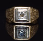 A 9ct gold ring set with a diamond of approximately 0.25ct with engraved decoration to the