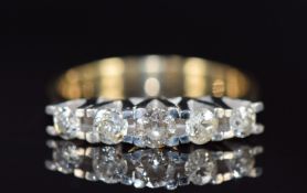 An 18ct gold ring set with five diamonds, the centre diamond approximately 0.21ct, 5.0g, size P
