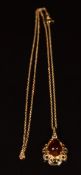 A 9ct gold pendant set with pressed amber, on 9ct gold chain, 2.5g