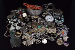A collection of silver jewellery including bangle, charm bracelet, scarf clip, brooches, lockets,