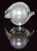 An 18ct white gold ring set with a 15.11ct South Sea pearl surrounded by round and baguette cut