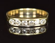 An 18ct gold ring set with six diamonds, each approximately 0.06ct, 3.3g, size K