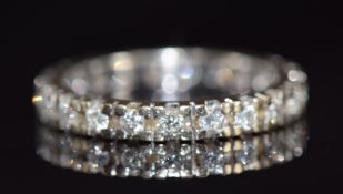An 18ct gold eternity ring set with diamonds, 3.2g, size L