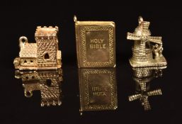 Three 9ct gold charms in the form of a church, a bible and a windmill, 8.3g
