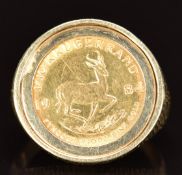 A 9ct gold ring set with a 1984 gold 1/10 Krugerrand, 7.1g, size L