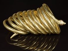 Silver gilt 800 grade cuff/ bangle in the form of a snake set with garnet eyes, maker ST, used in
