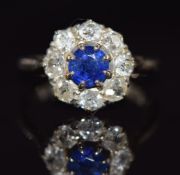An 18ct white gold ring set with a round cut sapphire of approximately 0.6ct surrounded by old cut