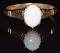 A 9ct gold ring set with an opal cabochon, 2.2g, size O