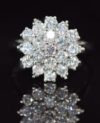 An 18ct white gold ring set with diamonds in a cluster, each diamond approximately 0.06ct, 5.8g,