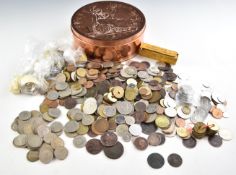 A collection of largely overseas coinage, 19thC onwards, some UK examples, in a penny shaped tin