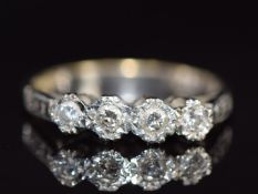 An 18ct white gold ring set with four diamonds in a platinum setting, 2.7g, size K