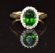 A 9ct gold ring set with an oval cut tourmaline surrounded by diamonds, 1.9g, size K