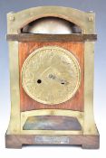 Oak and brass cased Arts & Crafts style mantel clock, with embossed dial, glass panel to base and