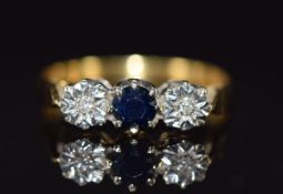 An 18ct gold ring set with a sapphire and diamonds. 3.2g, size P