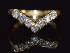 An 18ct gold V shape ring set with seven diamonds, each approximately 0.07ct, 2.6g, size J