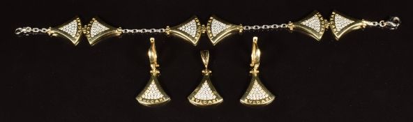A suite of 14k gold jewellery comprising bracelet, earrings and pendant set with cubic zirconia,