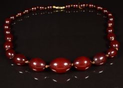 Art Deco cherry amber necklace made up of 30 oval beads, the largest 18 x 27mm, 46g