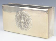Thai silver cigarette box with embossed decoration of a deity to lid, marked to base Alex & Co.