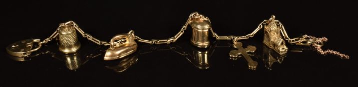 A 9ct gold charm bracelet with five 9ct gold charms including a church opening to reveal a wedding
