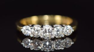 An 18ct gold ring set with five diamonds of approximately 0.3ct, 0.2ct, two 0.15ct, and 0.2ct, 5.0g,