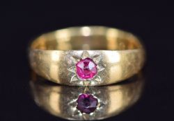 A c1910 18ct gold ring set with a ruby in a star setting, 3.9g, size M