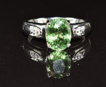 An 18k white gold ring set with paraiba tourmaline and diamonds, 4.7g, size M