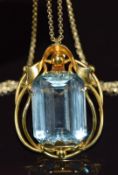 A 14k gold pendant set with an emerald cut aquamarine of approximately 18.5ct, on 14k gold chain,