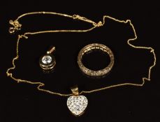 A 9ct gold eternity ring set with synthetic spinel, a 9ct gold chain and two pendants, 3.8g