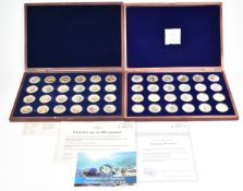Windsor Mint two sets of gold plated commemorative coins for fish and African wildlife, in deluxe