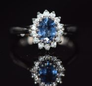A 9ct white gold ring set with a sapphire of approximately 0.8ct surrounded by diamonds, 3.3g,