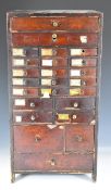 19th/20thC miniature / tabletop pine chest of 24 drawers full of mainly watch parts and tools