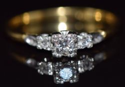 An 18ct gold ring set with three diamonds in a platinum setting, 3.4g, size T