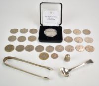 A pair of silver tongs, silver salt or mustard spoon, twenty collectable 50p pieces and two