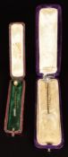 Two 9ct gold stick pins (c1900), both set with natural pearls (2.6g), in antique boxes
