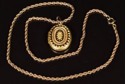 Victorian yellow metal locket with foliate decoration, on 9ct gold rope twist chain, 13.6g