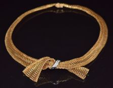 A c1960 18ct gold necklace made up of gold mesh in the form of a bow set with diamonds, 56g