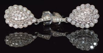 A pair of 9ct white gold earrings set with diamonds in a pear shaped setting, 3.3g