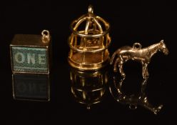 A 9ct gold pendant / charm in the form of a bird cage with two birds swinging, a 9ct gold charm