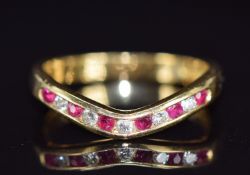 An 18ct gold half eternity ring set with rubies and diamonds, 3.7g, size O