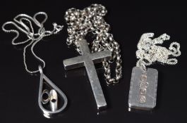 A silver ingot, silver cross and silver pendant, all on silver chains, 108g