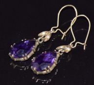 A pair of Edwardian 9ct gold earrings set with a pear cut amethyst and two seed pearls to each, 2.3g