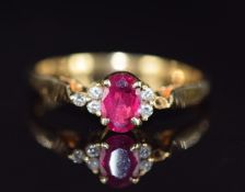 An 18ct gold ring set with an oval cut ruby and diamonds (one diamond missing), 2.7g, size N