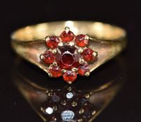 A 9ct gold ring set with garnets in a cluster, 2.2g, size O