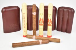 Three Monte Cristo cigars in metal cedarwood lined tubes, together with two Cuban Crafters leather