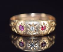 Edwardian 18ct gold ring set with a diamond and rubies in star settings, Birmingham 1909, 2.2g, size