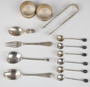 Mainly hallmarked silver cutlery comprising Georgian sugar tongs, set of six coffee bean spoons,
