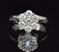 An 18ct white gold ring set with seven diamonds in a cluster, each diamond approximately 0.15ct, 4.