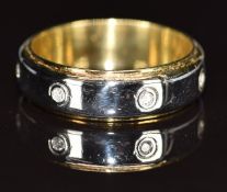 An 18ct gold bi-coloured ring set with seven diamonds, 7.3g, size O